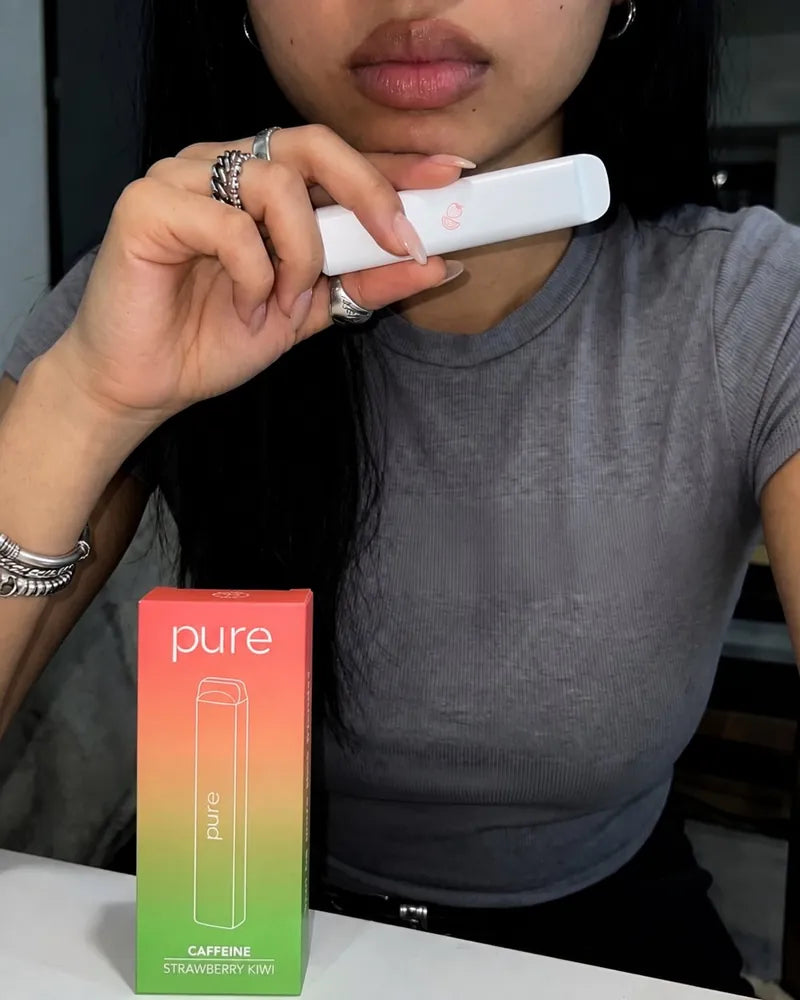 Customer holding her Pure Strawberry Kiwi diffuser with its box on the table