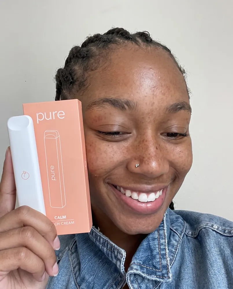 Smiling customer holding her Pure Peach Cream diffuser and box